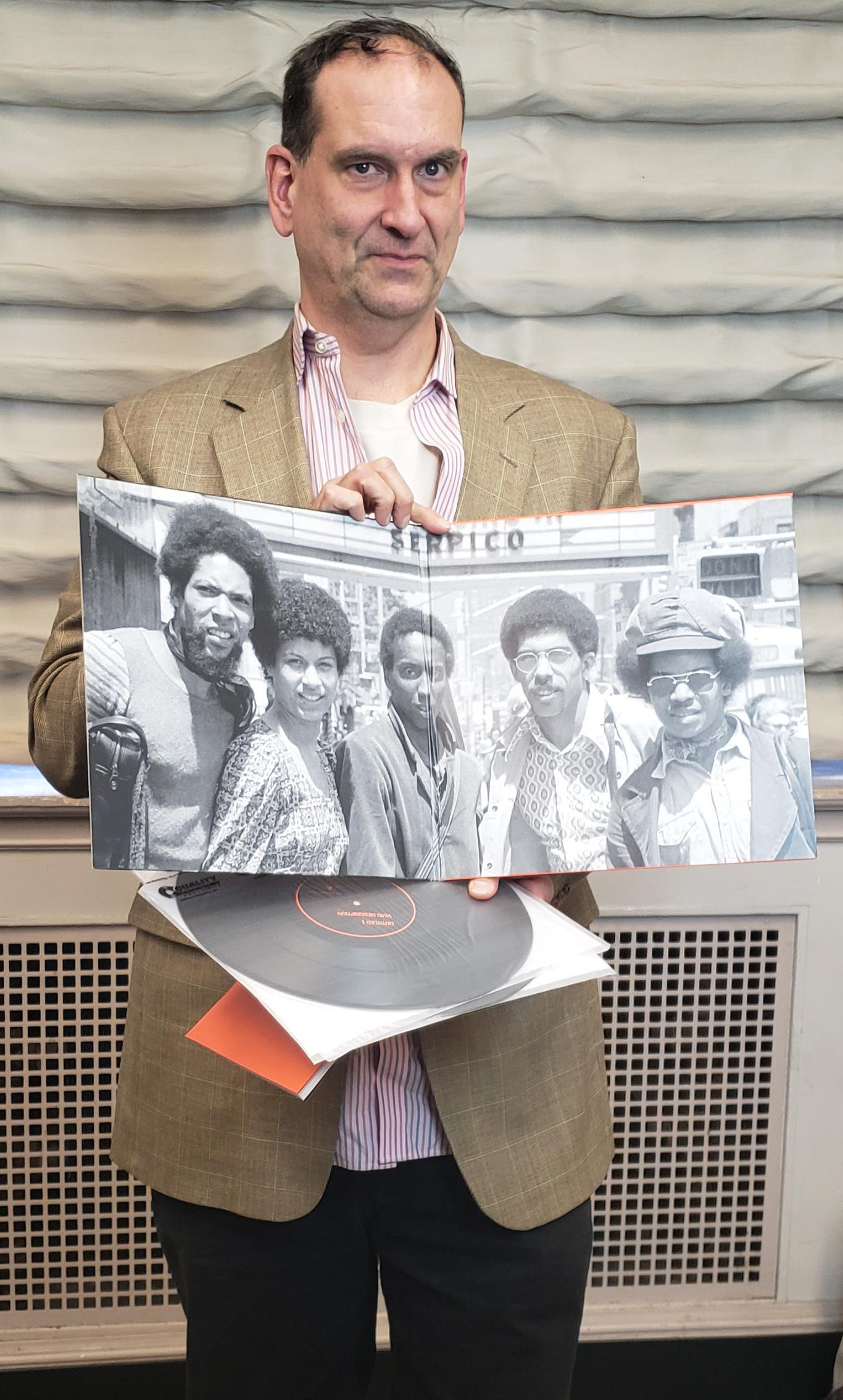 Ben Young holding one of his record's booklet